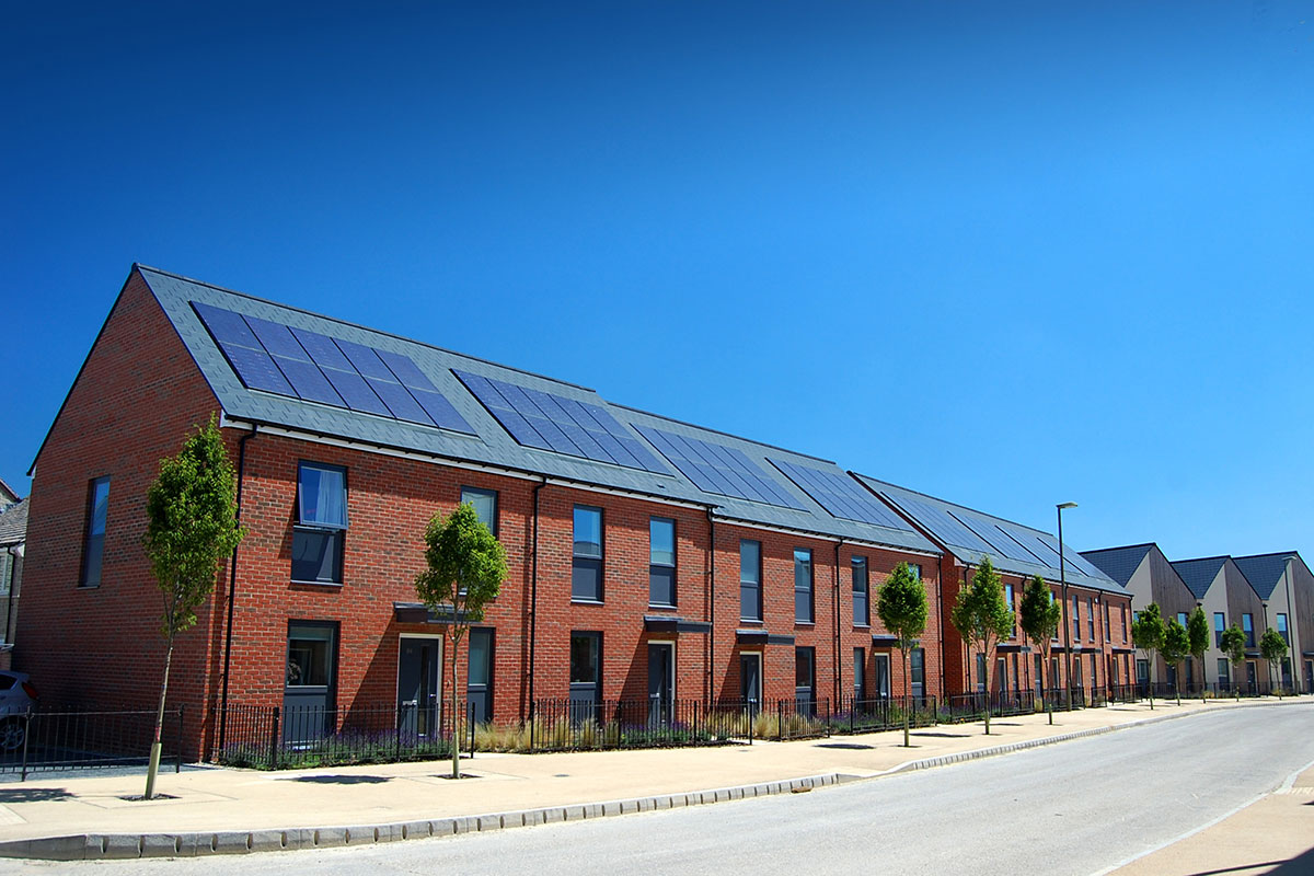 Team installing solar panels carefully onto a new build residential rooftop